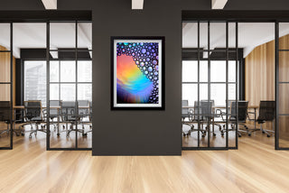Colorful abstract art on a wall in an office setting with large windows.