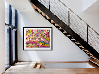 Colorful abstract art piece on a wall in a modern interior setting with stairs.