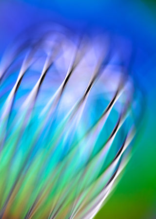 Abstract close-up of a kitchen whisk with a gradient background