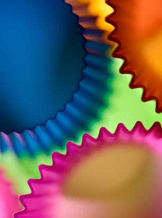 Close-up of colorful plastic cupcake liners with a blurred focus.