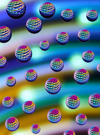Pattern of colorful, multicolored spherical objects on a gradient background
