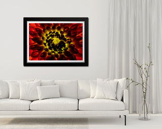 Framed abstract art piece on a wall above a white sofa